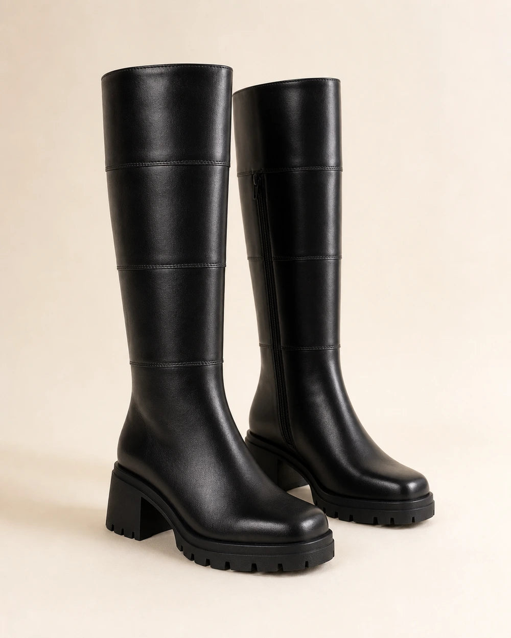 Women's black chunky knee-high boots, full silhouette.