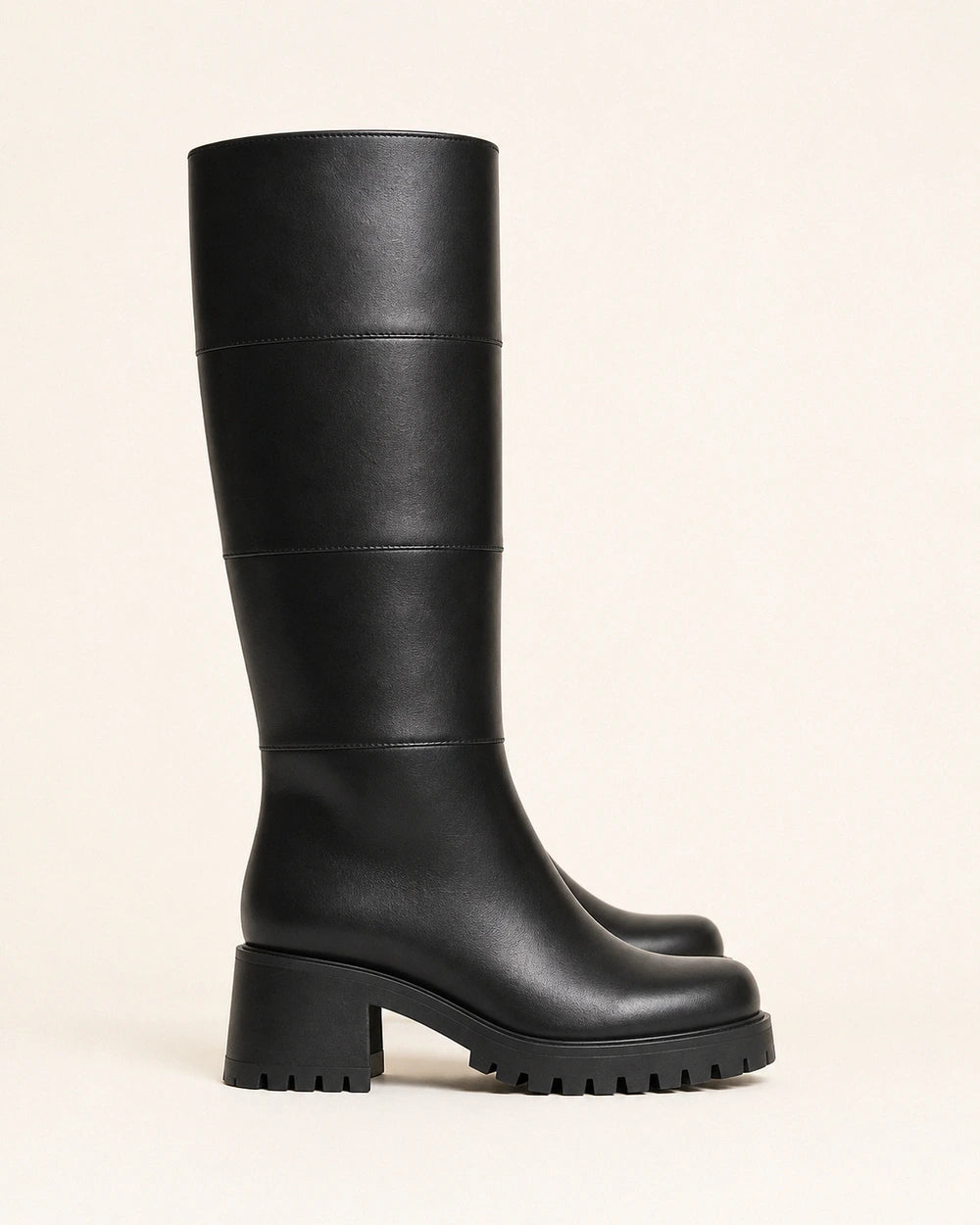 Women's black chunky knee-high boots, lateral profile.
